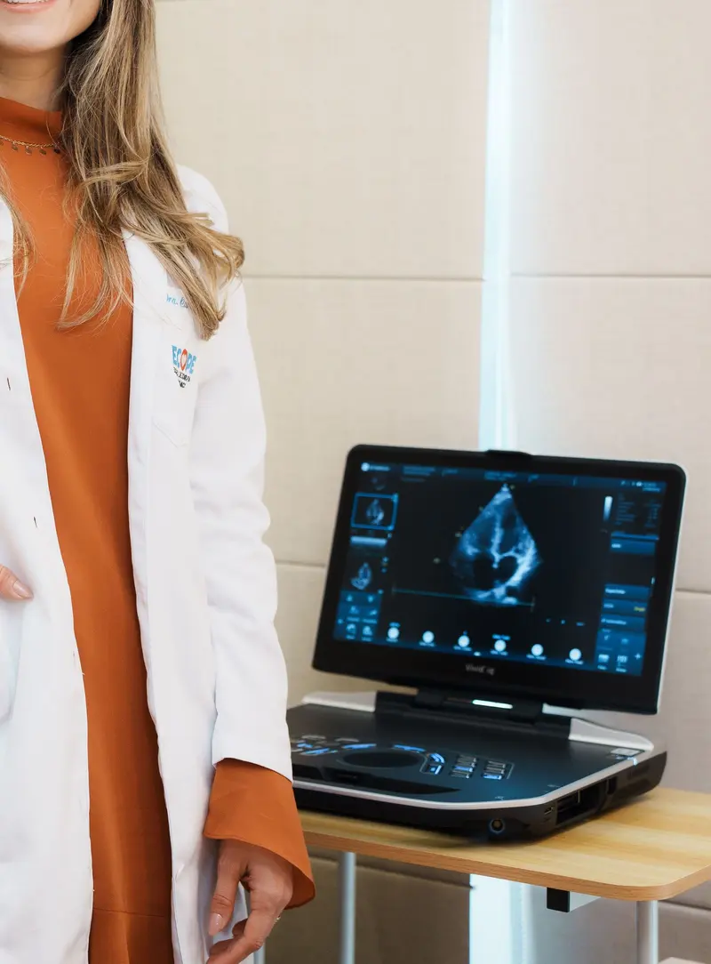 O aparelho de ecocardiograma portátil, ligado, com a imagem do coração na tela